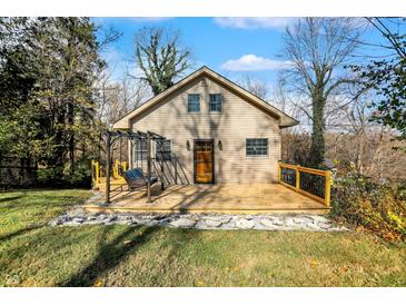 Charming home with a beautiful front deck, complete with a cozy swing and lovely landscaping at 7335 Bethany Park, Martinsville, IN 46151