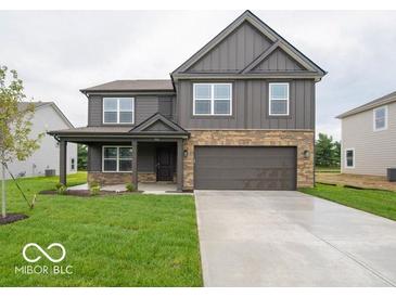 Two-story home with gray siding, stone accents, covered porch, and two-car garage at 7517 Big Bend Blvd, Camby, IN 46113