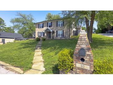 Charming two-story brick home with landscaped yard and inviting front entrance at 80 E College Ave, Martinsville, IN 46151