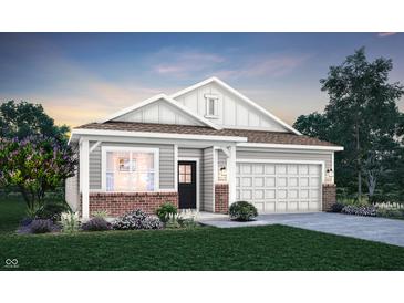 Charming single-Gathering home featuring a two-car garage and manicured front yard, perfect for suburban living at 9363 Abner St, McCordsville, IN 46055