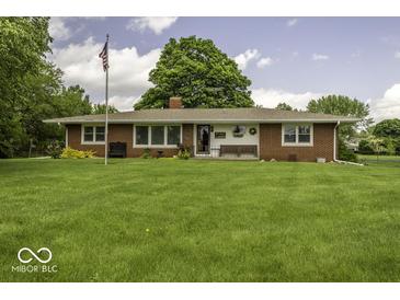Charming single-story brick home with a large front yard and American flag at 1190 W Jefferson St, Franklin, IN 46131