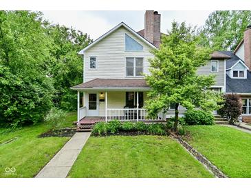 Charming two-story home with a front porch and well-maintained lawn at 1236 Central Ave, Indianapolis, IN 46202