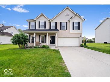 Charming two-story home featuring brick accents, a well-manicured lawn, and an attached two-car garage at 12832 Broncos Dr, Fishers, IN 46037