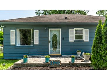 Charming single-story home with a welcoming front porch, beautiful landscaping, and great curb appeal at 1747 S Irvington Ave, Indianapolis, IN 46203