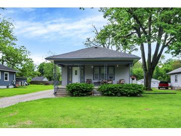 Charming home featuring a cozy front porch, well-manicured lawn, and inviting curb appeal at 2150 S Emerson Ave, Indianapolis, IN 46203