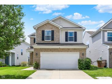Inviting two-story home with stone accents, a two-car garage, and well-maintained landscaping at 2473 Shadow Bend Dr, Columbus, IN 47201