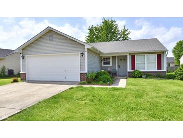 Charming single-story home with a well-maintained lawn, a two-car garage, and inviting curb appeal at 6556 Wandering Way, Indianapolis, IN 46241