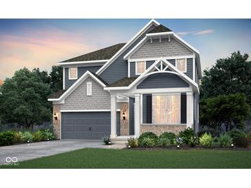 Beautiful two-story home with gray siding, stone accents, a covered porch, and well-manicured landscaping at 6833 Jacone Dr, Brownsburg, IN 46112