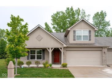 Charming exterior elevation of home featuring brick accents, covered porch, attached garage and manicured front lawn at 808 Heartland Ln, Brownsburg, IN 46112