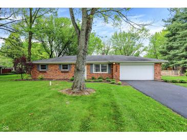 Charming single-story brick home featuring a well-maintained lawn and attached garage at 820 S Eaglewood Dr, Zionsville, IN 46077
