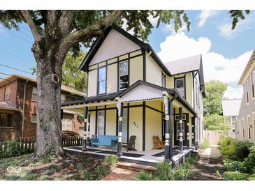 Charming two-story home boasts a welcoming front porch and beautifully maintained landscaping at 847 N Park Ave, Indianapolis, IN 46202