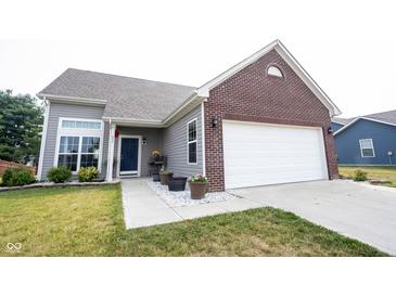 Charming home with gray siding, brick accents, manicured lawn, and an attached two-car garage at 895 Geronimo Dr, Greenfield, IN 46140