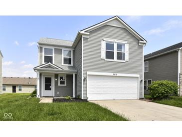 Charming two-story home with a two-car garage, light gray siding, and a well-maintained front lawn at 9676 W Constellation Dr, Pendleton, IN 46064