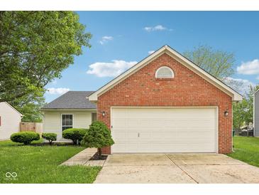 Charming home with a two-car garage featuring a brick facade and well-maintained landscaping at 1093 Country Meadow Ct, Franklin, IN 46131