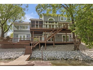 Spacious backyard featuring a multi-level deck, stone accents, and access to the water at 11226 Blackwalnut Pt, Indianapolis, IN 46236