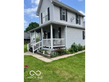 Charming two-story home with inviting front porch and tidy landscaping at 1517 S Reisner St, Indianapolis, IN 46221
