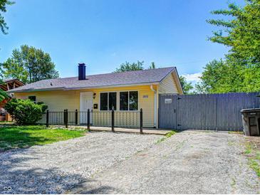 Charming yellow home with gravel driveway and well-maintained lawn at 3072 Falcon Dr, Indianapolis, IN 46222
