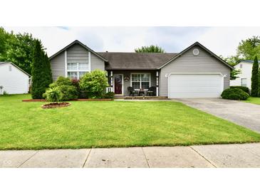 Charming single-story home with manicured lawn, covered porch, and attached two-car garage at 73 Suncrest Dr, Greenwood, IN 46143