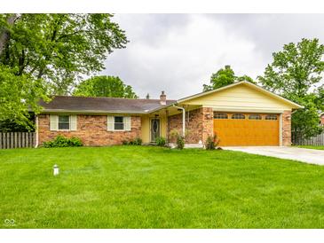 Charming single-story brick home featuring a well-maintained lawn and an attached two-car garage at 7580 Sherry Ln, Brownsburg, IN 46112