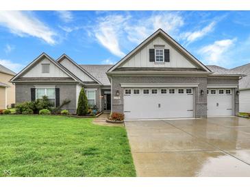 Charming single-Gathering home with a brick facade, well-manicured lawn, and a spacious three-car garage at 1334 Sunnybrook Ln, Greenwood, IN 46143