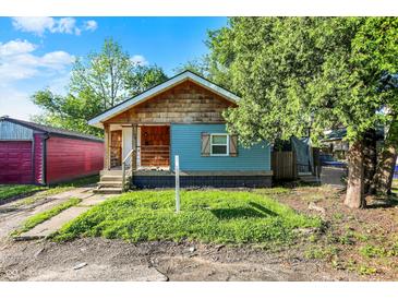 Charming single-story home with blue siding and wood shingle accents; great curb appeal at 3109 E St Joseph St, Indianapolis, IN 46201