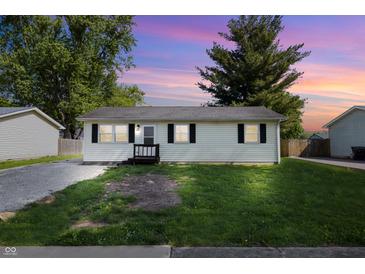 Charming single-story home featuring well-maintained landscaping and neutral siding at 410 W Douglas St, Martinsville, IN 46151