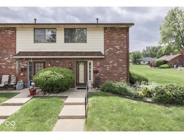Charming townhome with brick facade, manicured lawn, and inviting entrance at 57 Trails End St, Greenwood, IN 46142