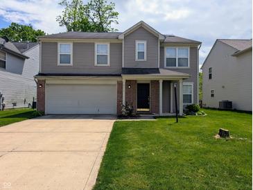 Two-story home with gray siding, a brick-accented garage, and a well-manicured front lawn at 6715 Shanghai Cir, Indianapolis, IN 46278