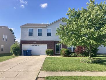 Charming two-story home featuring brick accents, a well-manicured lawn, and an attached two-car garage at 6824 W Philadelphia Dr, McCordsville, IN 46055