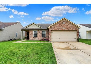 Charming brick home featuring an attached two-car garage and a well-maintained front lawn at 8904 Browns Valley Ln, Camby, IN 46113