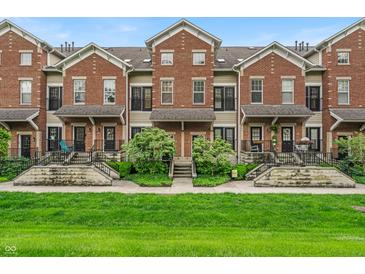Charming townhomes with brick facade, manicured lawns, and inviting front entrances at 1064 Reserve Way, Indianapolis, IN 46220