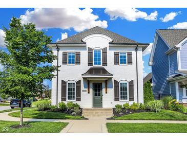 Charming two-story home with white brick, manicured lawn and mature landscaping at 15116 Fenchurch Dr, Westfield, IN 46074