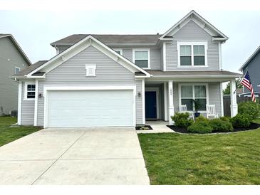 Charming two-story home with a well-manicured lawn, white garage door, and welcoming front porch at 1880 Explorer Ct, Franklin, IN 46131