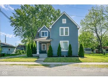 Charming two-story home with blue siding, manicured lawn, and symmetrical landscaping at 2215 S Delaware St, Indianapolis, IN 46225