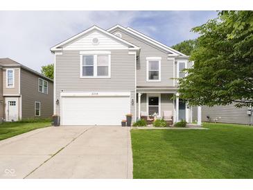 Charming two-story home featuring a two-car garage and a cozy front porch with seating area at 2258 Bridlewood Dr, Franklin, IN 46131