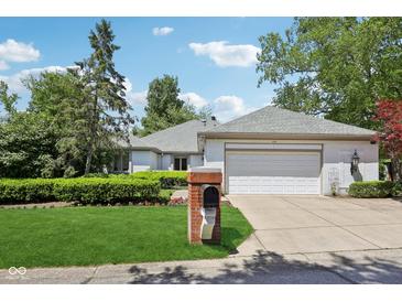 Charming single-story home with manicured lawn, brick mailbox, and attached two-car garage at 410 Sugar Tree Ln, Indianapolis, IN 46260