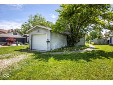 Detached one-car garage with gravel driveway and tree at 4625 N Sadlier Dr, Indianapolis, IN 46226