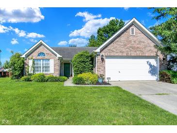 Charming single-story brick home featuring a well-manicured lawn and attached two car garage at 4824 Eagles Watch Ln, Indianapolis, IN 46254