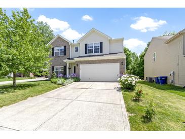 Charming two-story home featuring a two-car garage, well-manicured lawn, and inviting curb appeal at 5145 Greenside Dr, Indianapolis, IN 46235