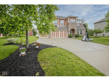 Charming two-story home with a well-manicured front yard and three-car garage at 548 Gosford Ct, Westfield, IN 46074