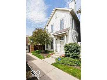 Charming two-story home with well-manicured landscaping, inviting entrance, and plenty of natural light at 654 N Senate Ave, Indianapolis, IN 46202