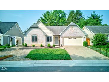 Charming brick home with well-maintained landscaping, complemented by a two-car attached garage at 12258 Charing Cross Rd, Carmel, IN 46033