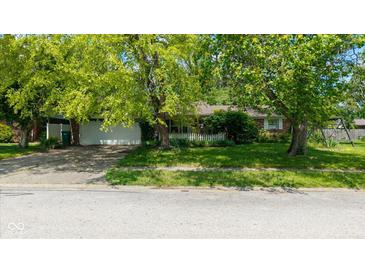 Charming one-story brick home with a two car garage and a lovely white picket fence at 1416 Miami S Ct, Plainfield, IN 46168