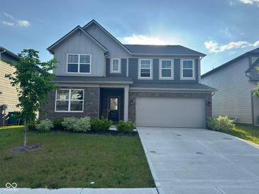 Beautiful two-story home with brick and siding, lush lawn, and a two-car garage at 2263 S Carlota Dr, New Palestine, IN 46163