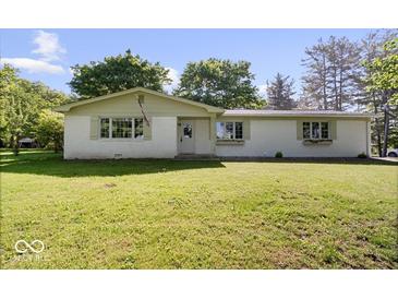 Charming single-story home featuring a well-maintained lawn and inviting facade at 305 N 1100 E, Zionsville, IN 46077