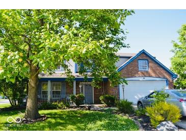 Charming two-story home with brick accents, a covered porch, and a well-manicured lawn at 6056 Blackley Ct, Indianapolis, IN 46254