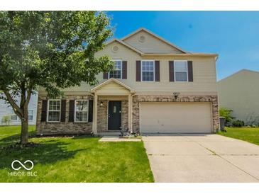 Charming two-story home with a well-maintained lawn and a two-car garage at 6213 Selago Dr, Indianapolis, IN 46203