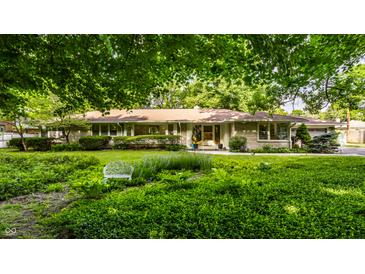 Charming brick ranch home with mature trees and well-manicured front yard at 6220 Spring Mill Rd, Indianapolis, IN 46260