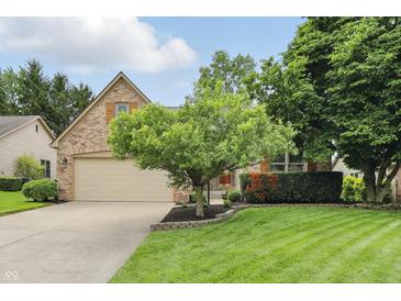 Charming single-Gathering home with a two-car garage, well-maintained lawn and mature trees at 7329 Pymbroke Dr, Fishers, IN 46038