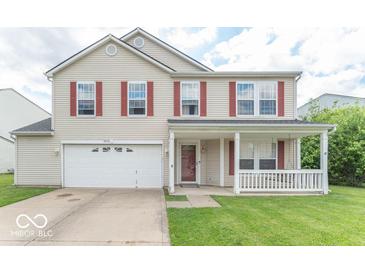 Charming two-story home featuring a covered front porch, red shutters, and a well-maintained lawn at 8712 Mellot Way, Camby, IN 46113